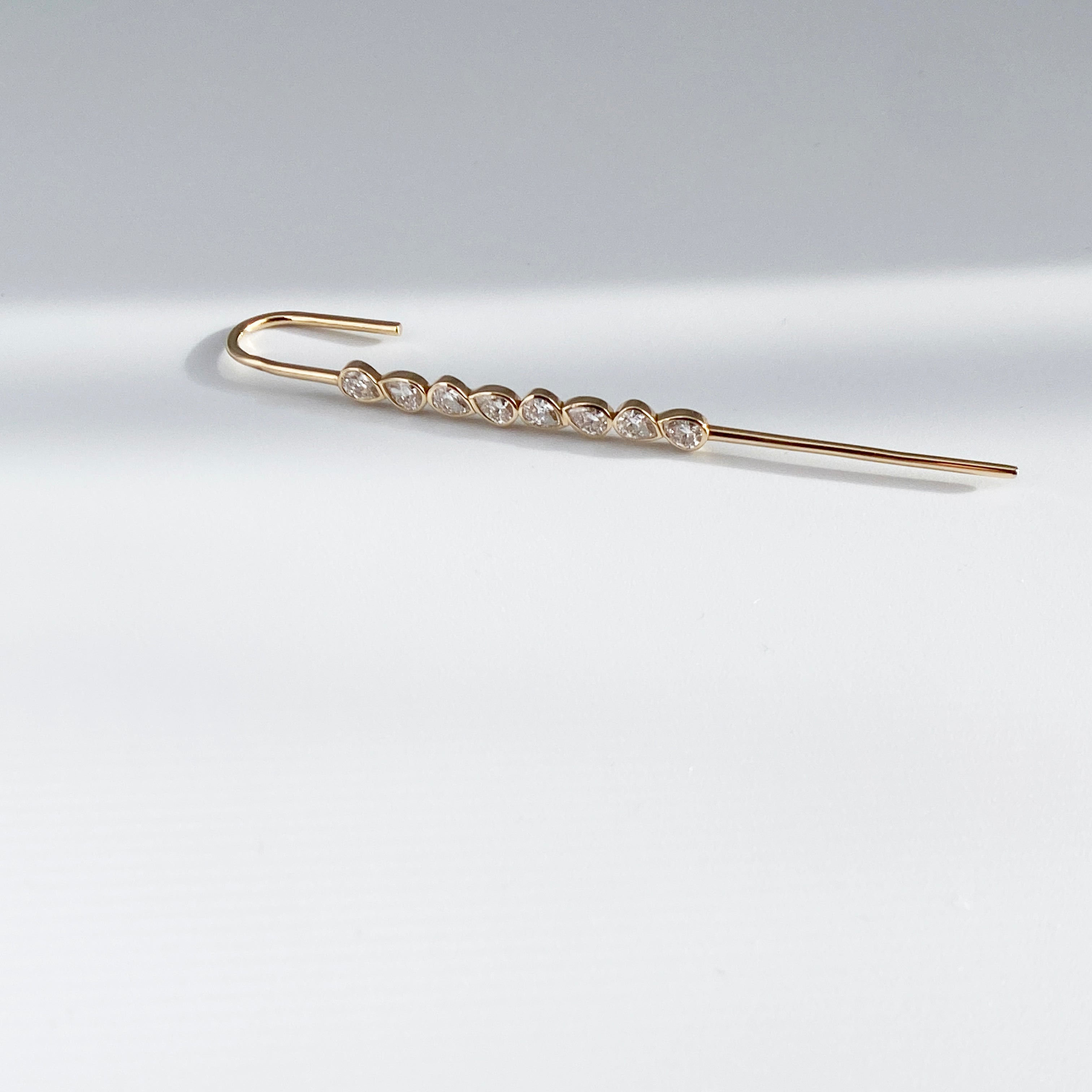 14k gold modern ear pin earring on a white background